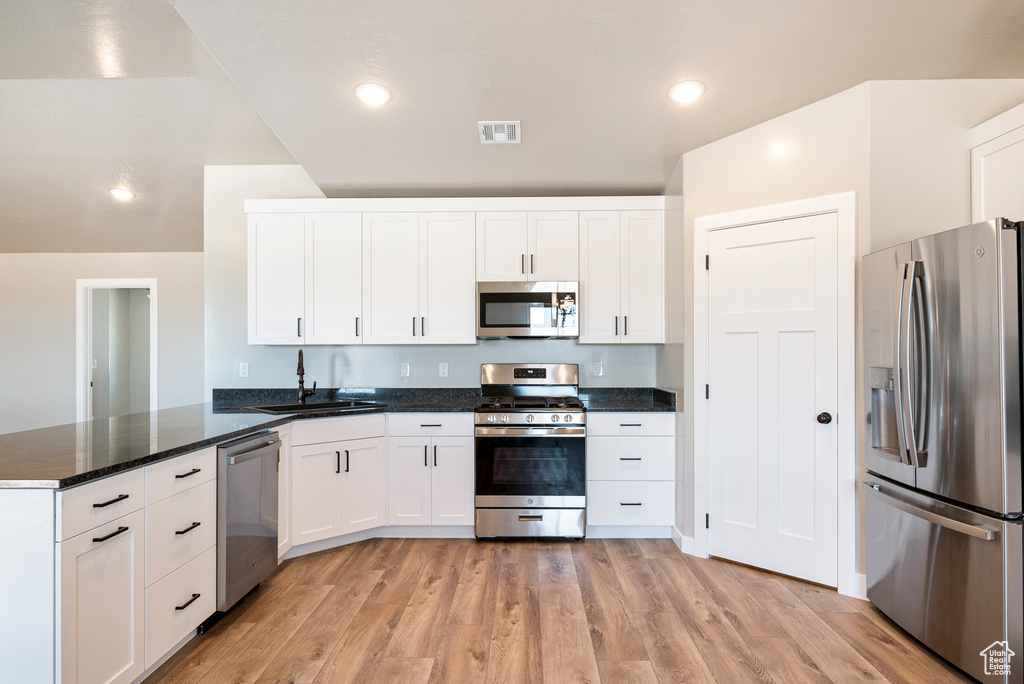 Kitchen featuring light hardwood / wood-style flooring, stainless steel appliances, sink, and kitchen peninsula