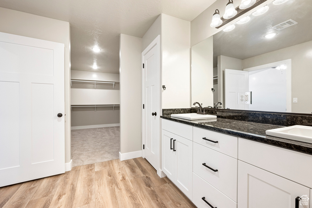 Bathroom with vanity and hardwood / wood-style flooring