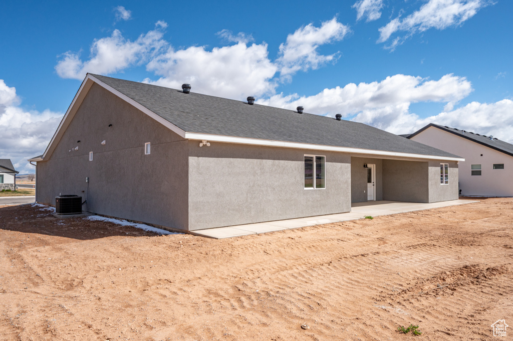 Rear view of property with central air condition unit, a patio, and stucco siding