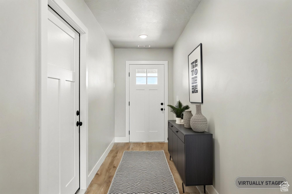 Entryway featuring light wood-style floors and baseboards