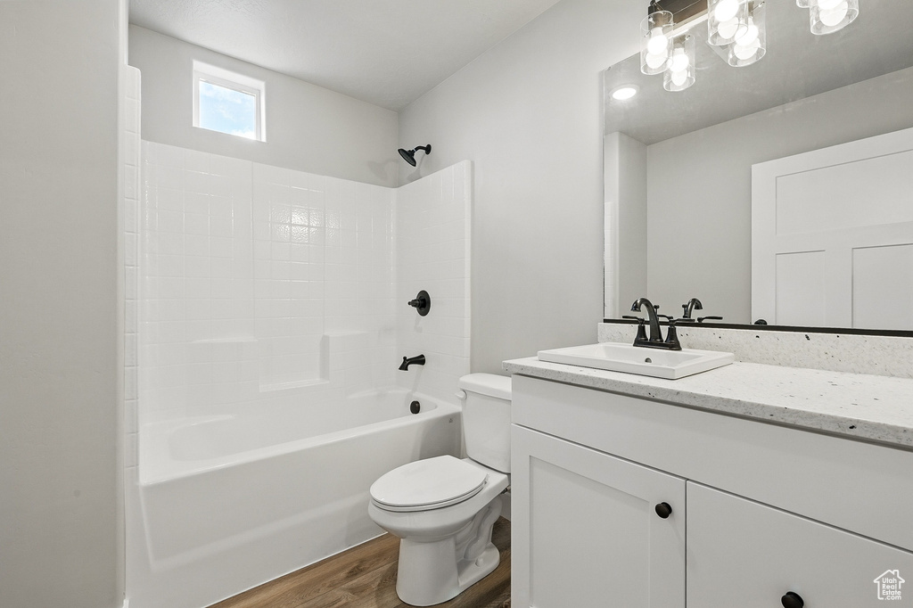 Full bathroom featuring shower / bathtub combination, vanity, toilet, and wood finished floors