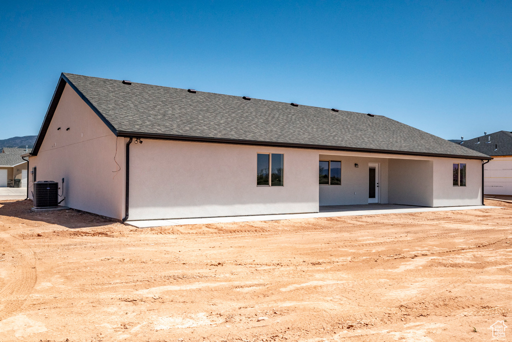 Rear view of property with central AC and a patio area