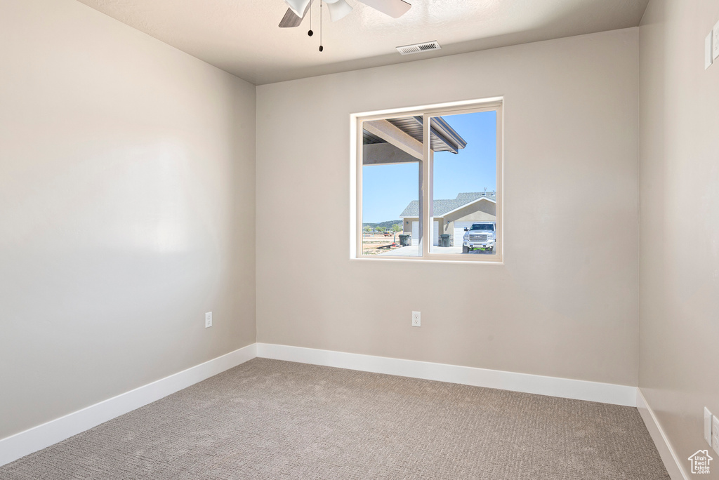 Empty room with ceiling fan and carpet