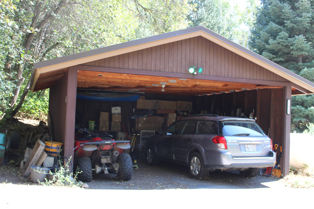 Garage featuring a carport