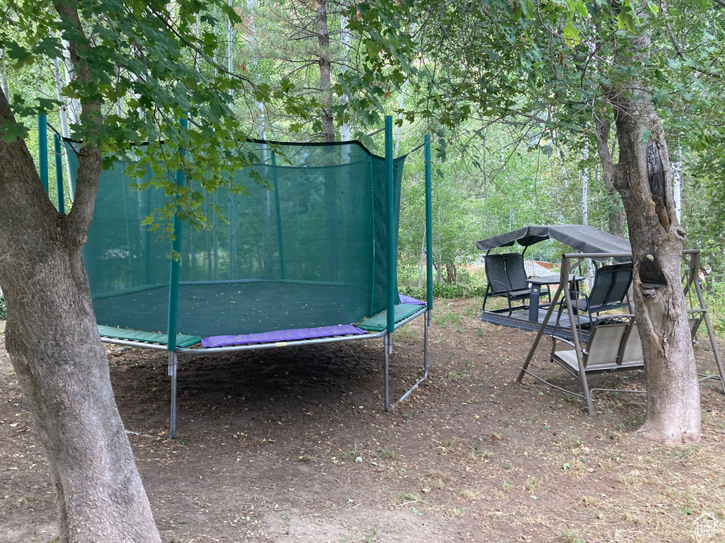 View of yard with a trampoline