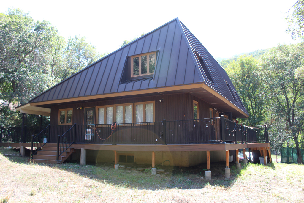 View of side of home with a deck