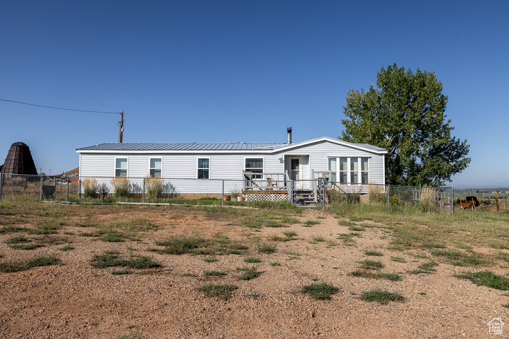 Rear view of house featuring a wooden deck