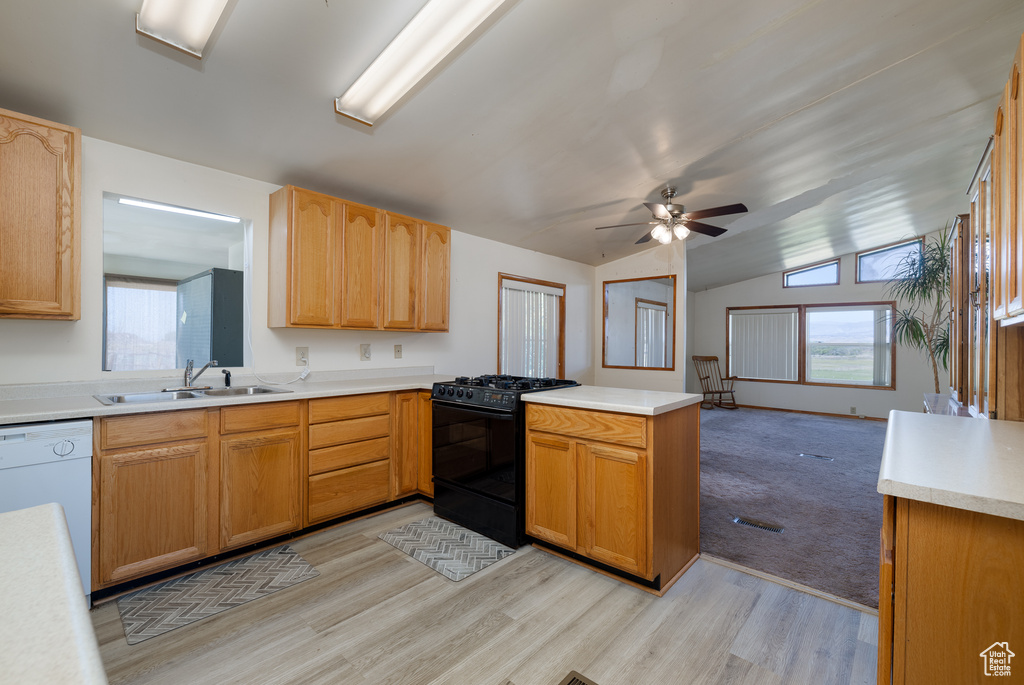 Kitchen featuring ceiling fan, black range with gas cooktop, sink, and a healthy amount of sunlight