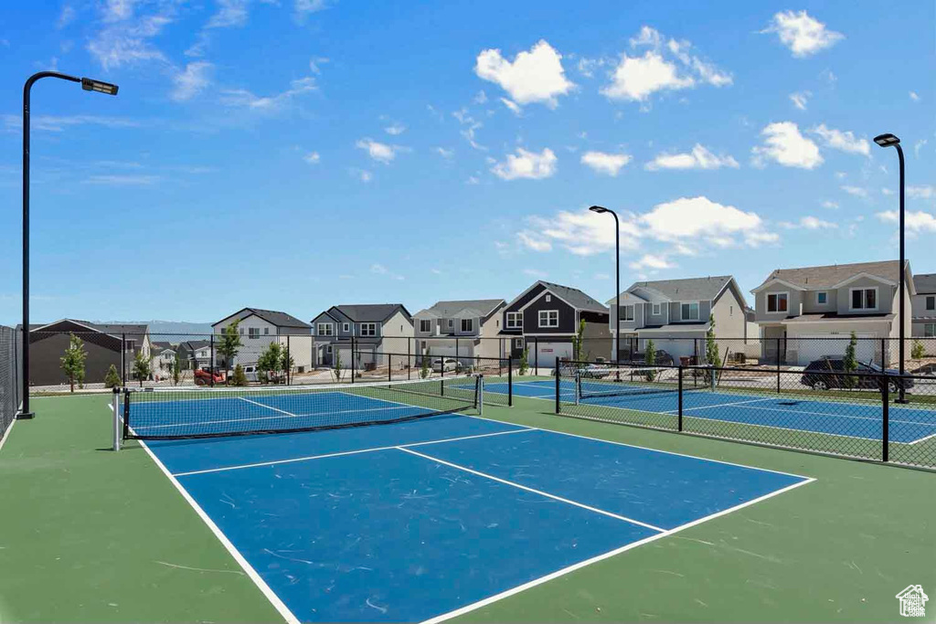 View of tennis court featuring a residential view