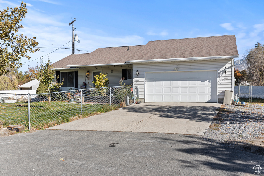Ranch-style home featuring a garage and a front yard