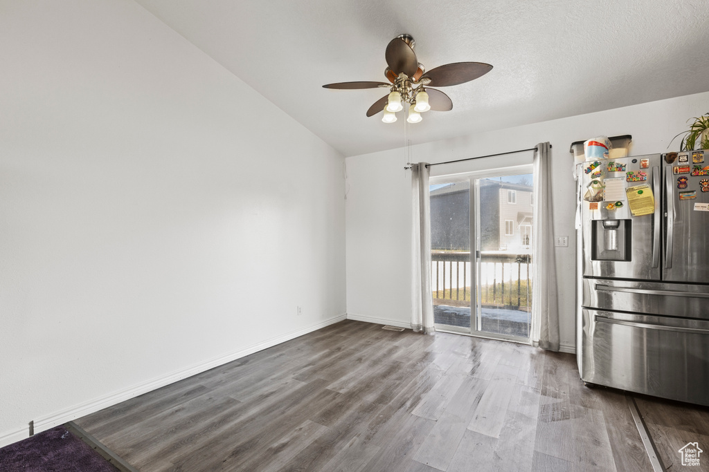Unfurnished dining area featuring a textured ceiling, wood-type flooring, and ceiling fan