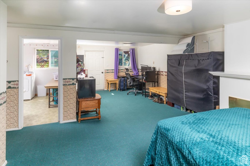 Bedroom with washer / dryer, carpet, and crown molding