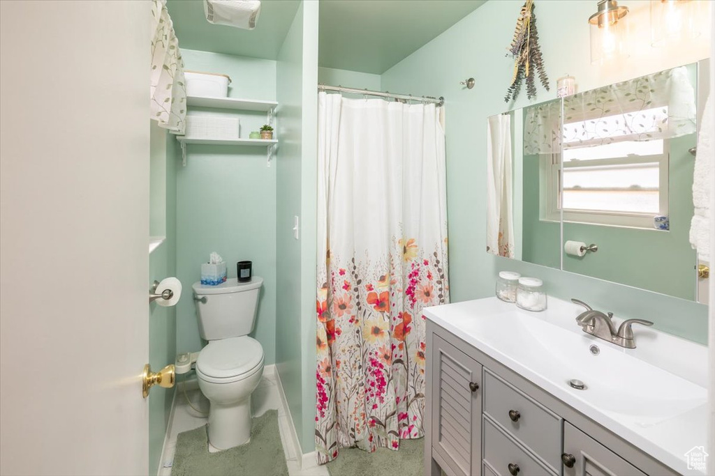 Bathroom with vanity, toilet, and walk in shower