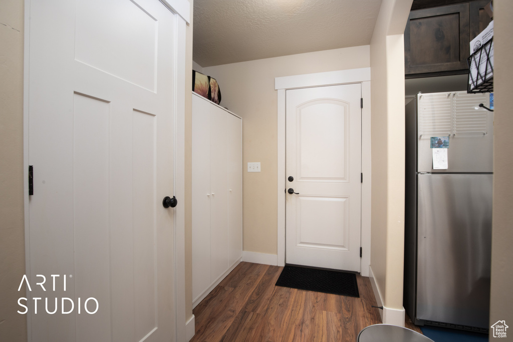 Mudroom with a textured ceiling and dark hardwood / wood-style floors