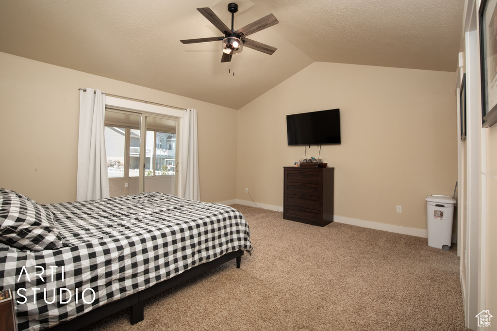 Bedroom with ceiling fan, carpet, and vaulted ceiling