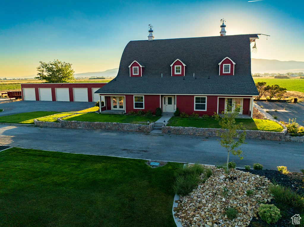 Cape cod-style house with a lawn and a garage
