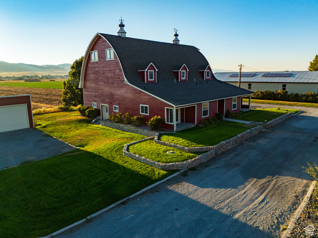 View of front facade with a front lawn, a garage, and a mountain view