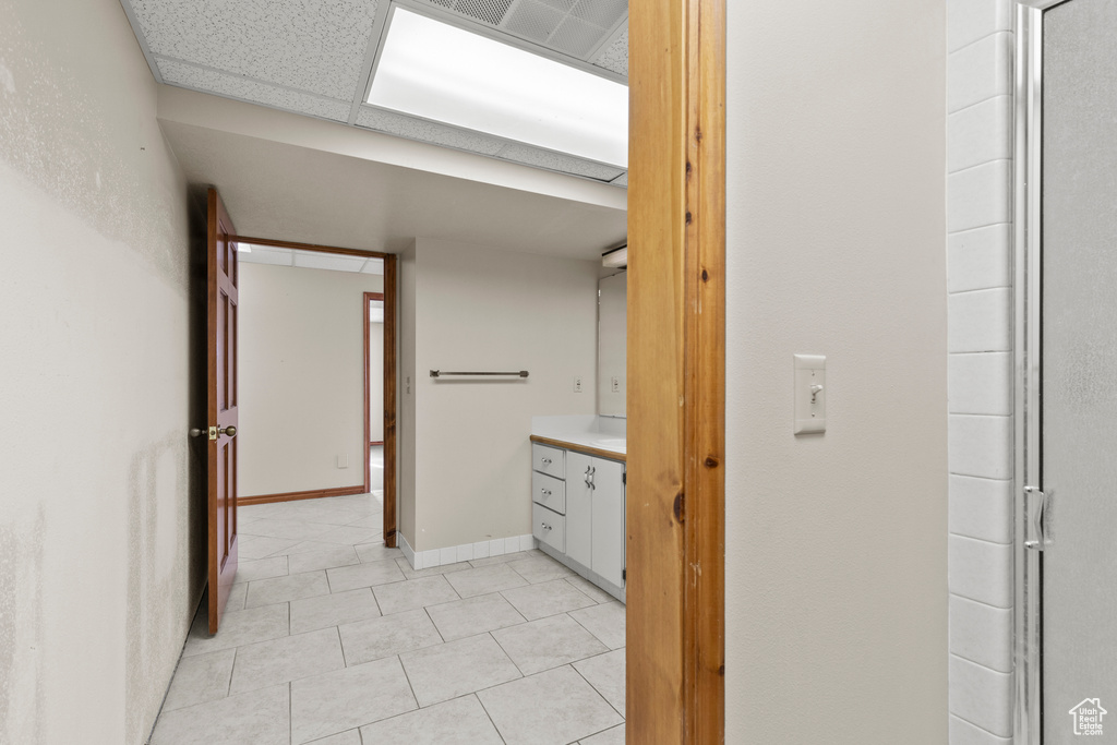 Bathroom with tile patterned floors and baseboards