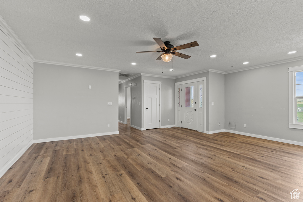Spare room featuring ceiling fan, recessed lighting, wood finished floors, ornamental molding, and baseboards