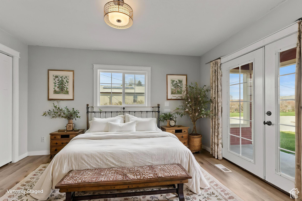 Bedroom with access to exterior, light wood-style floors, french doors, and baseboards
