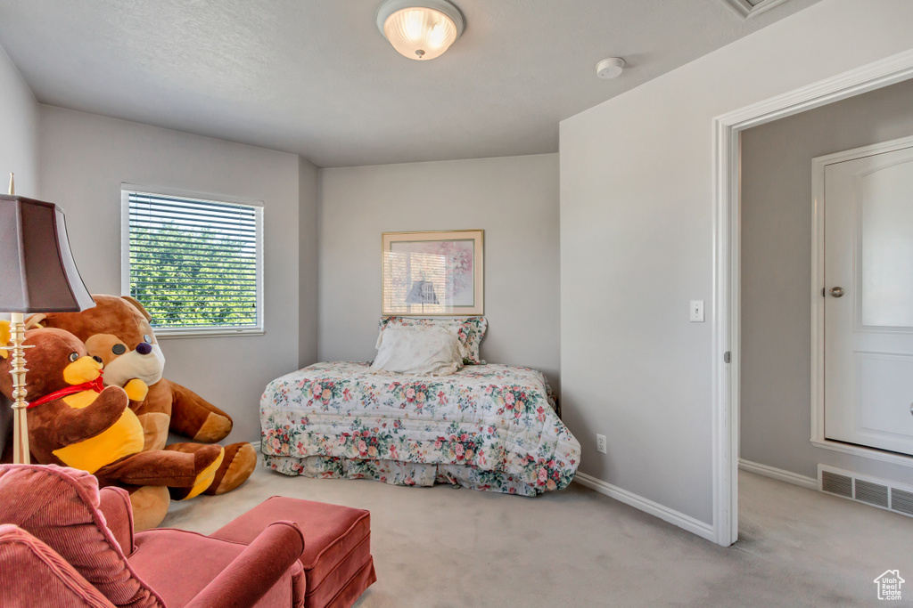 Bedroom with light colored carpet