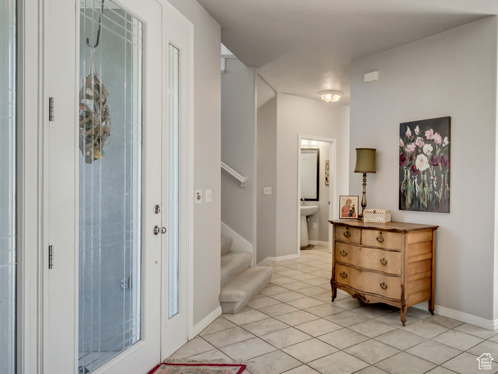 Entrance foyer featuring an inviting chandelier and light tile patterned floors