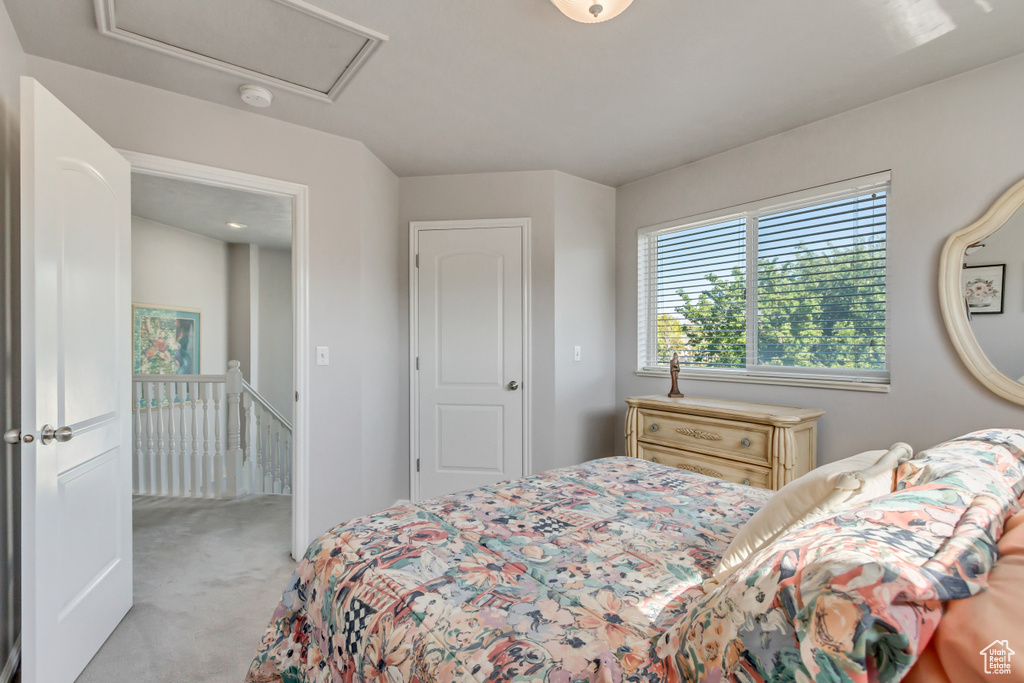 Bedroom featuring light colored carpet