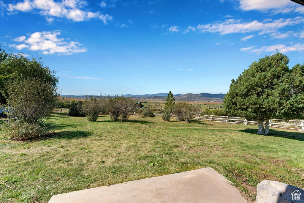 View of yard with a rural view and a mountain view