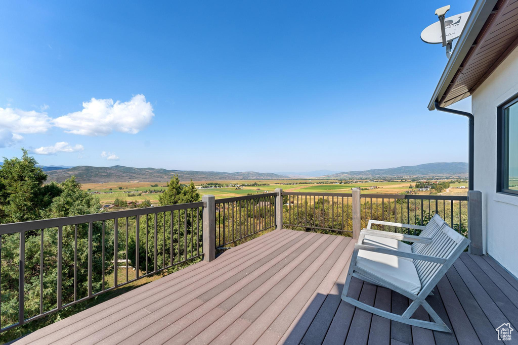 Deck with a mountain view and a rural view