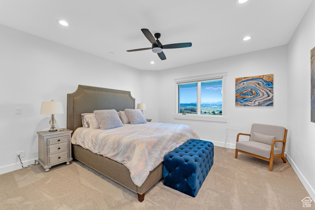 Bedroom featuring light carpet and ceiling fan