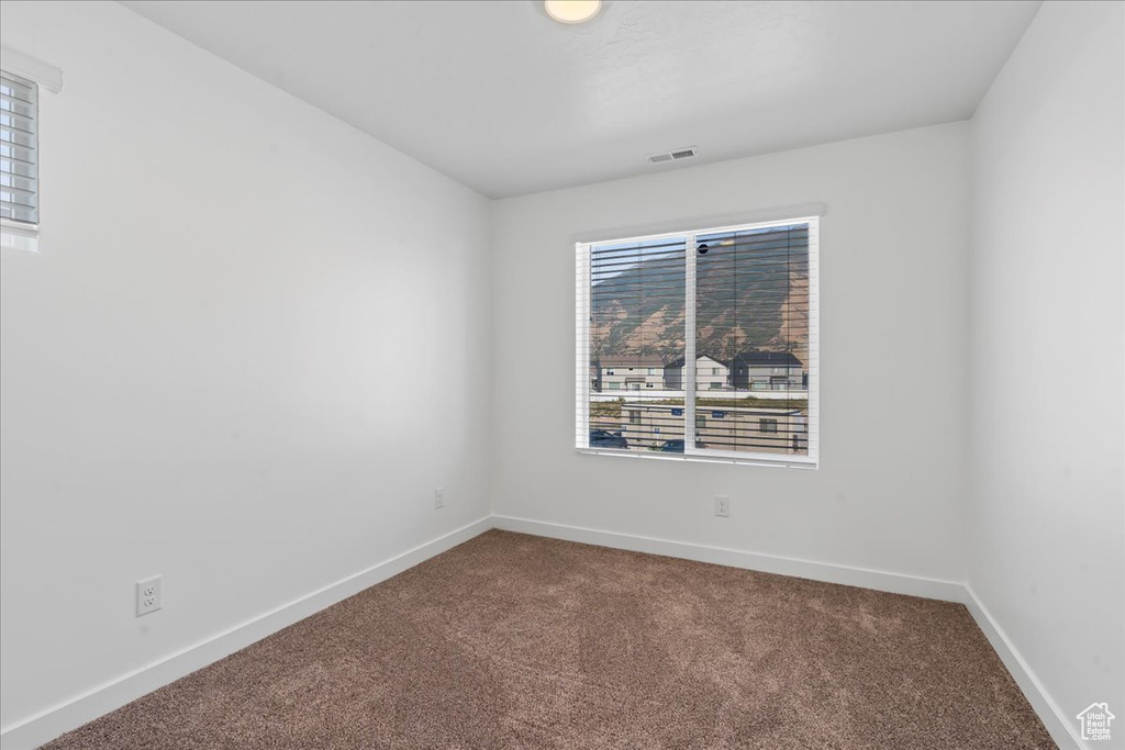 Unfurnished room featuring carpet