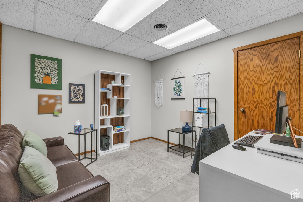 Office area with a paneled ceiling