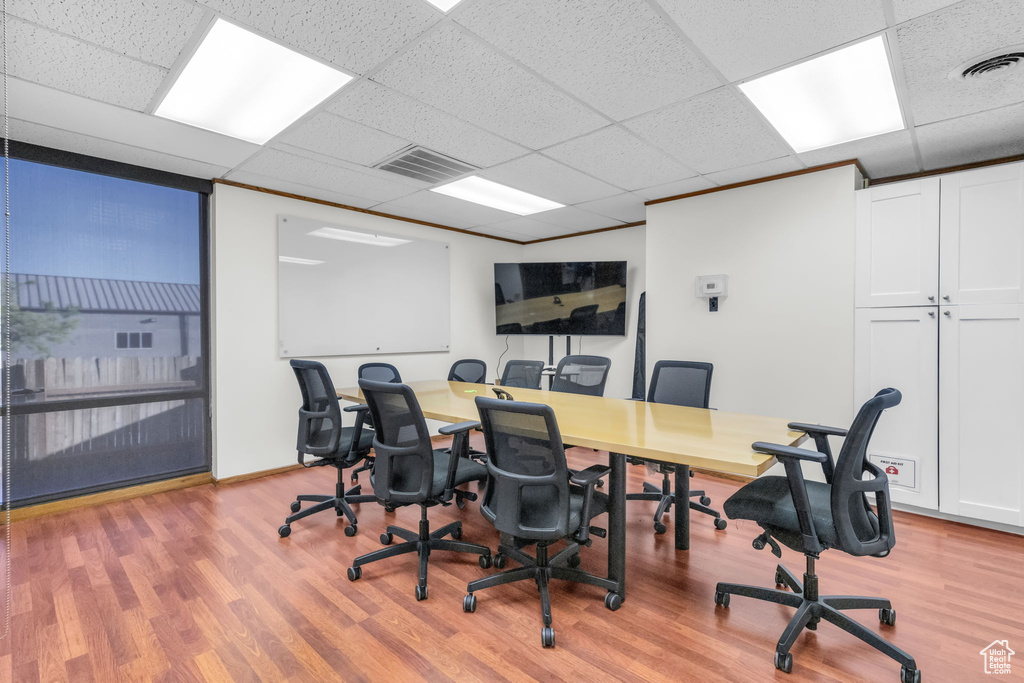 Home office featuring hardwood / wood-style floors and a drop ceiling