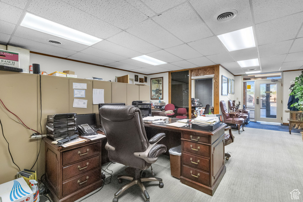 Office space with light colored carpet, french doors, and a drop ceiling