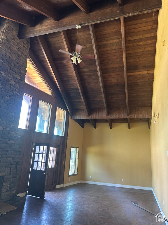 Interior space featuring ceiling fan, beamed ceiling, high vaulted ceiling, and wooden ceiling