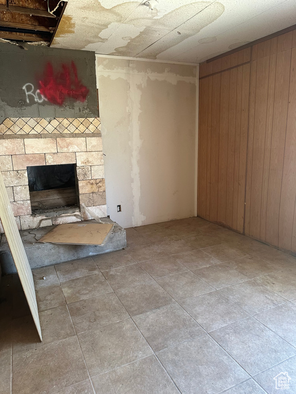 Unfurnished living room with a stone fireplace