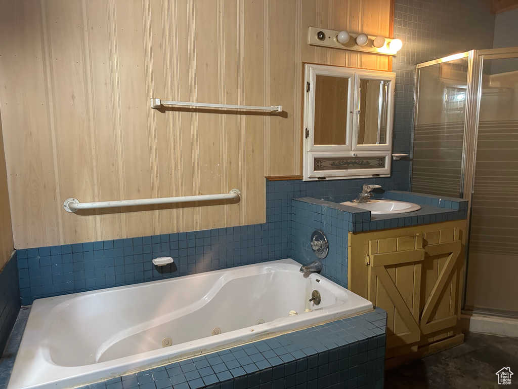 Bathroom with shower with separate bathtub and vanity