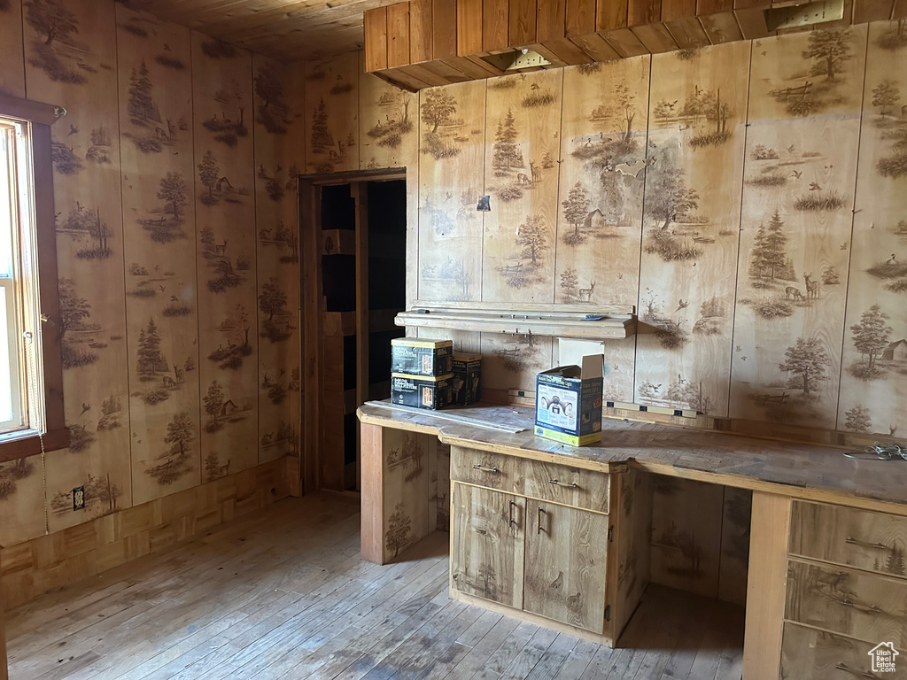 Interior space with wood ceiling and light hardwood / wood-style flooring