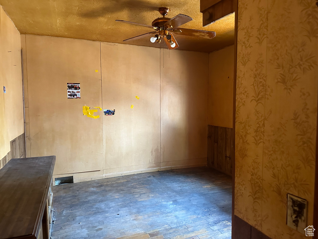 Unfurnished room with ceiling fan and a textured ceiling