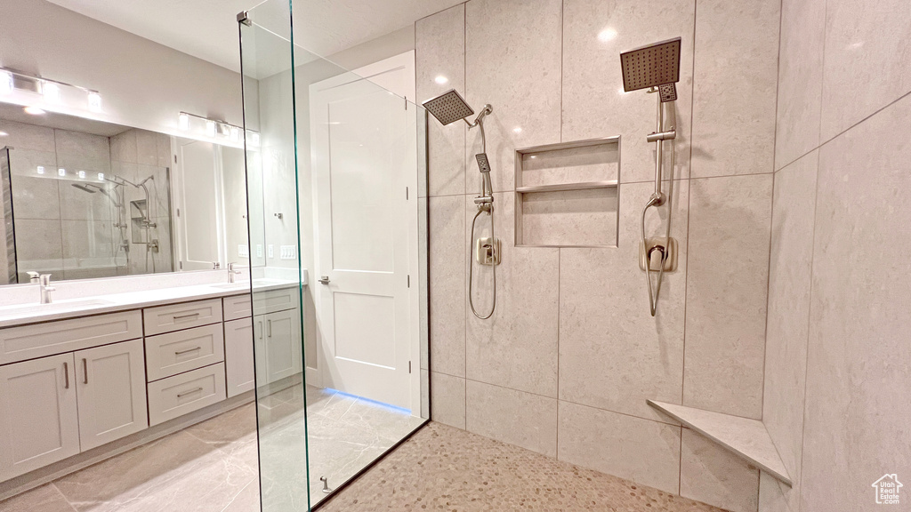 Bathroom featuring vanity and tiled shower