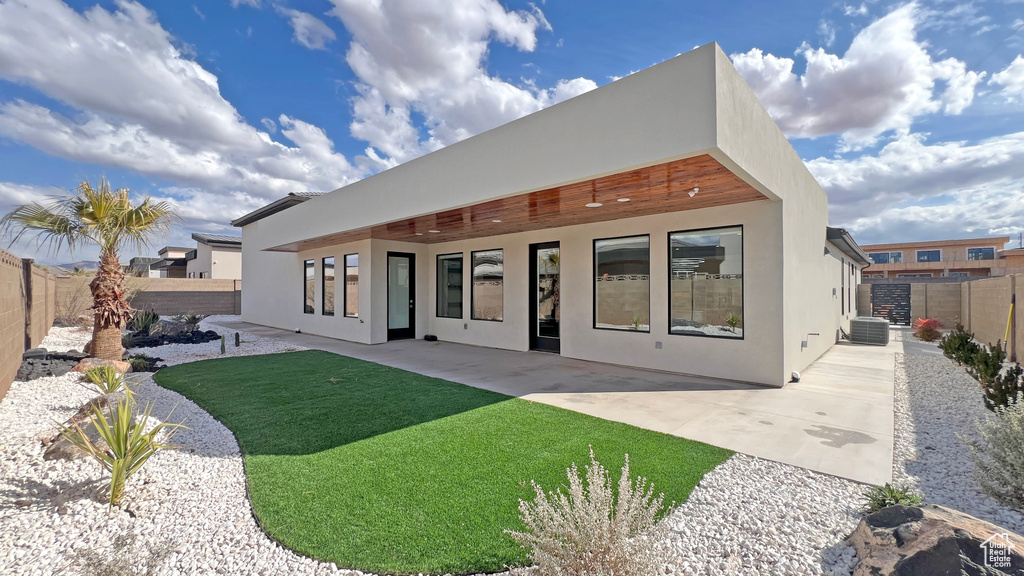 Rear view of property with a patio area and central air condition unit