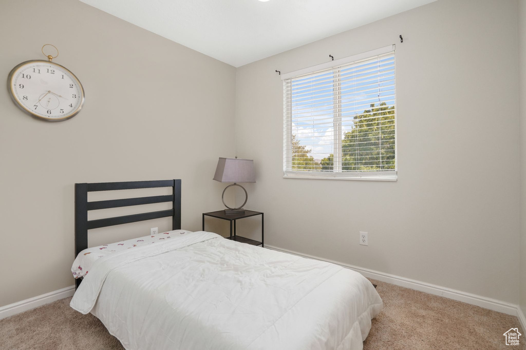 Bedroom with light colored carpet