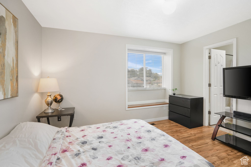 Bedroom with light hardwood / wood-style flooring