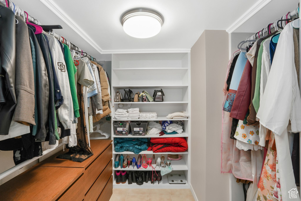 Spacious closet featuring light tile patterned flooring