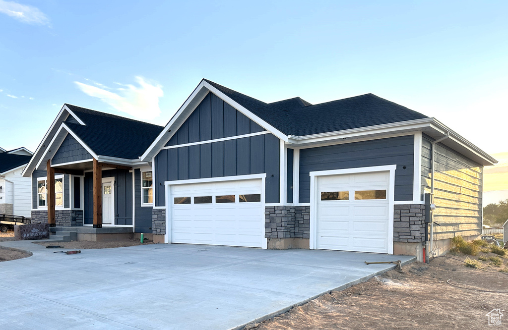 View of front of home featuring a garage and a porch