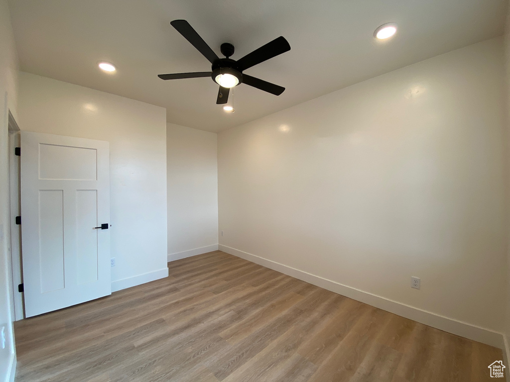 Spare room with hardwood / wood-style floors and ceiling fan