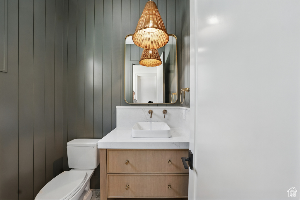 Half bathroom with vanity and toilet