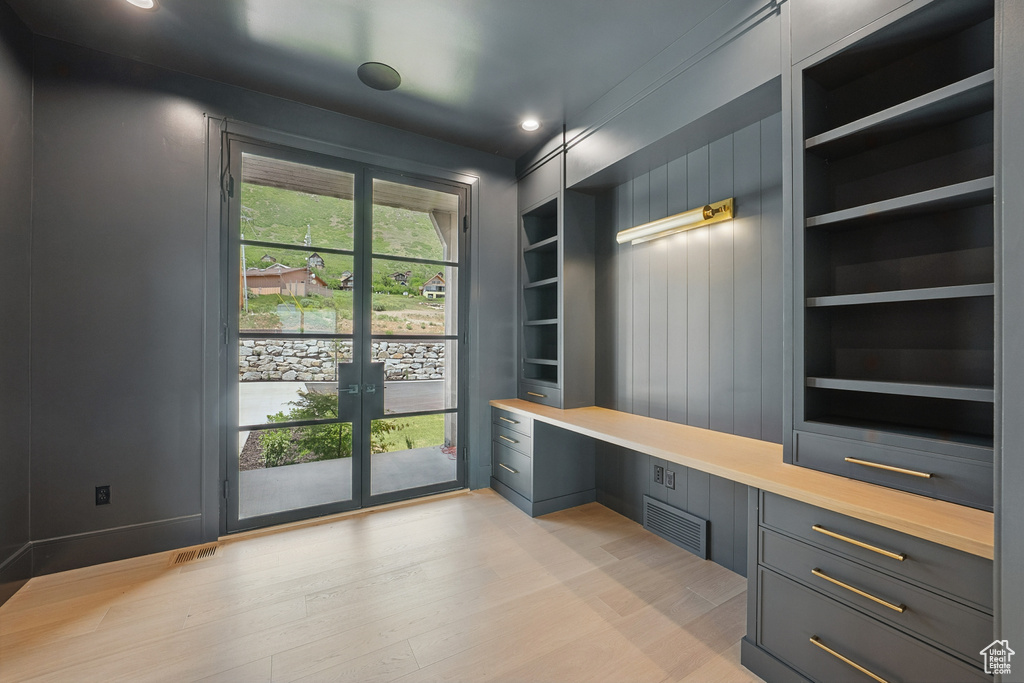 Mudroom featuring built in desk, french doors, built in shelves, light wood-style floors, and recessed lighting