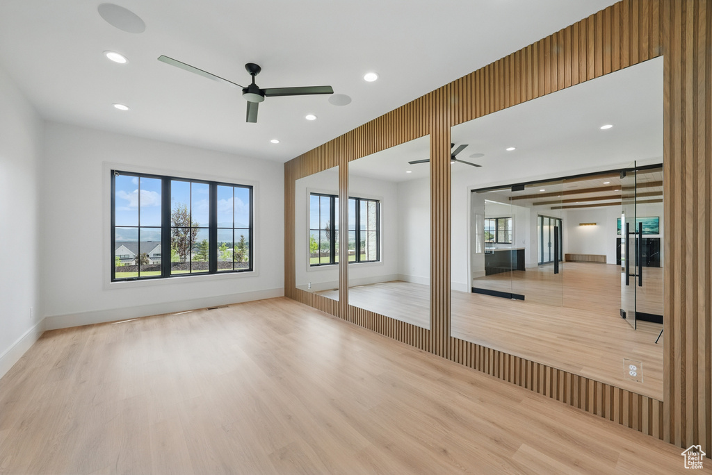 Spare room with ceiling fan, wood finished floors, recessed lighting, and baseboards