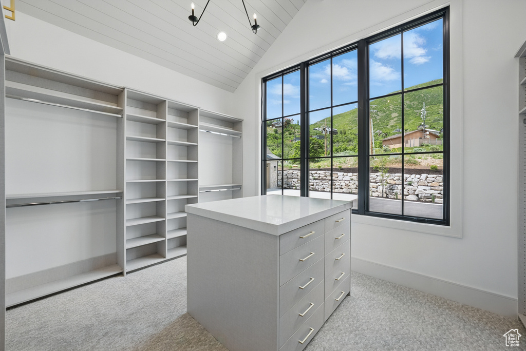 Spacious closet featuring carpet and vaulted ceiling